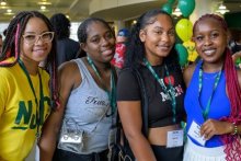 four female students pose