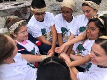 STUDENTS GATHERED, LINKED HANDS