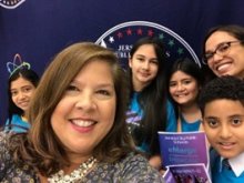 teacher posed with students behind her